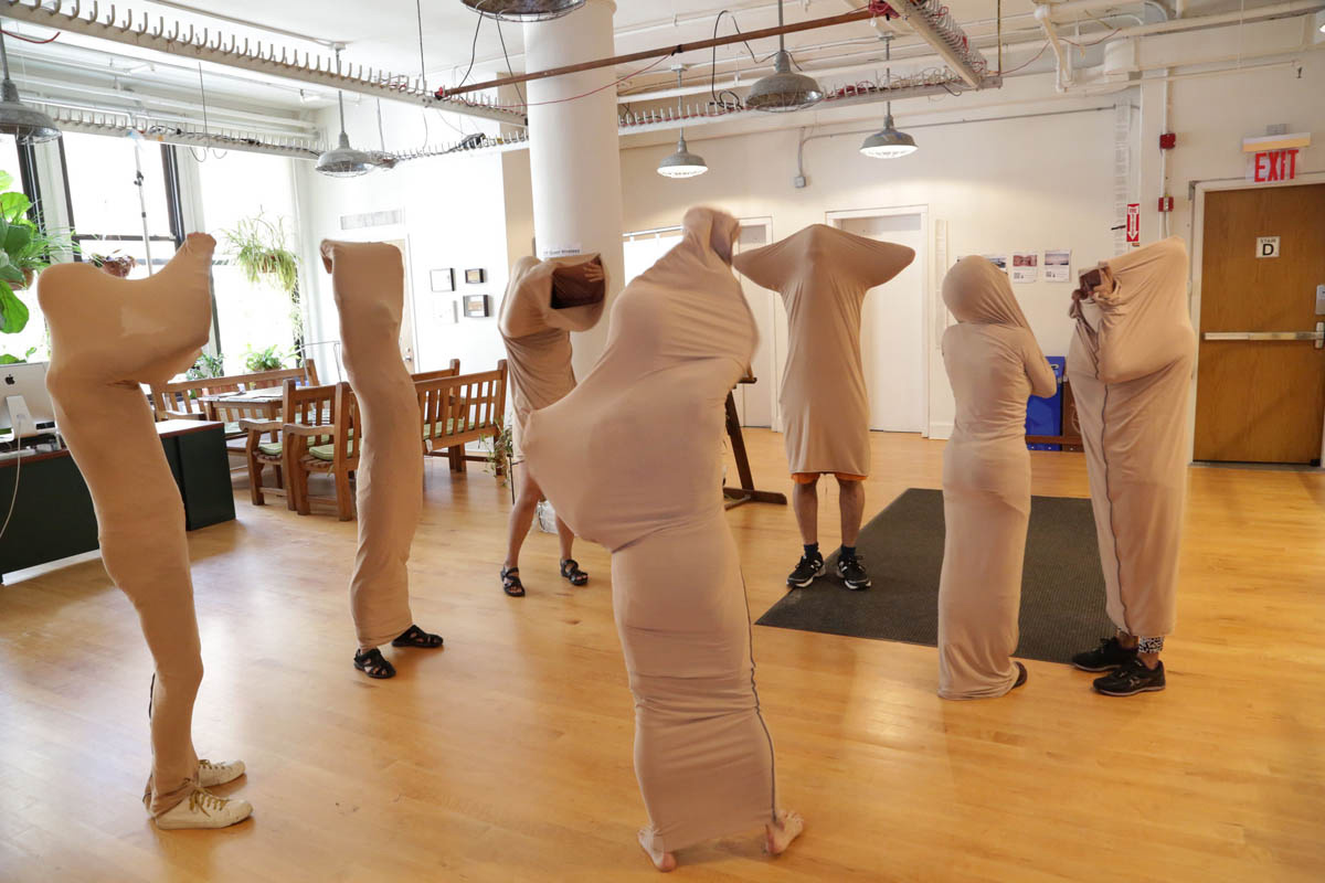a group of people wearing nylon bags over their bodies